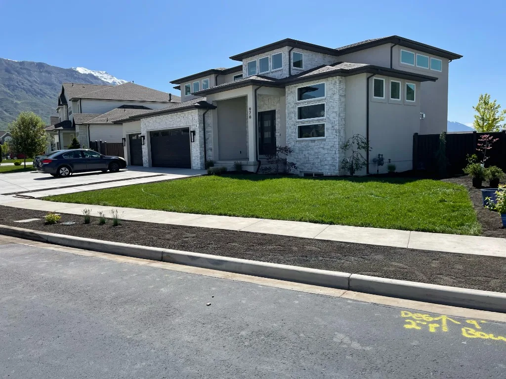 Front Yard Sod — After — Fresh sod, clean planting beds, and a manicured front lawn that transforms curb appeal.